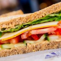 Harvest Veggie Sandwich · Vegetarian. Harvest veggie sandwich, hummus is topped with tomatoes, cucumbers, carrots, pro...