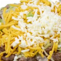 Bean Tostada · Thin layer of beans, cheddar, lettuce, topped with jack cheese.