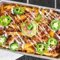 Smothered Brisket Fries · Topped with beef brisket, applewood bacon, cheddar jack cheese and Voodoo Ranger Queso, lime...