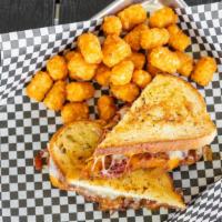 Brisket Loaded Grilled Cheese · Smoky beef brisket, cheddar and American cheeses and caramelized onions on artisan sourdough