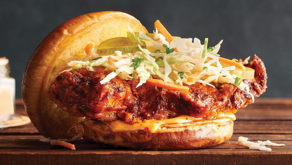 Nashville Hot Chicken Sandwich  · Crispy Nashville-style hot chicken breast topped with dill pickles, creamy coleslaw and spicy aioli