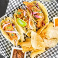 Baja Fish Tacos  · Crispy-fried ﬁsh, shredded cabbage, pickled onions and chipotle aioli. Served with habanero ...