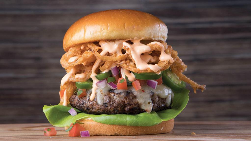 Voodoo Burger · Blackened seasoning, pepper jack cheese, pico de gallo, fresh jalapeños, Tabasco®-fried onion straws, lettuce and chipotle aioli