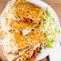 Quesadilla · Flour tortillas stuffed with melted cheese, onions mild chilies, tomatoes served with sour c...