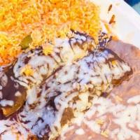 Mole Enchilada · Two corn tortillas stuffed with tender chunk chicken, topped with delicious sweet, spicy Mex...