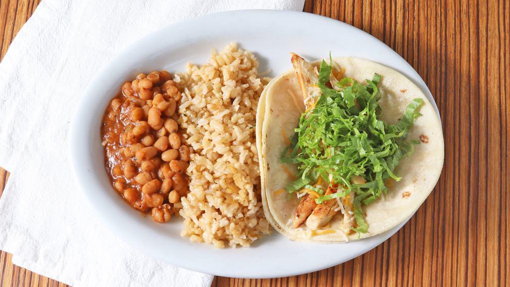 Kid'S Taco Plate. · one taco with only Cheese and Lettuce or Cabbage  served with rice and beans.