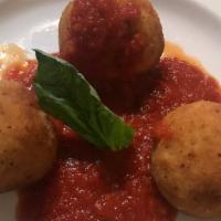 Suppli Di Riso · Risotto rice balls with smoked mozzarella center, breaded and served with our fresh tomato s...