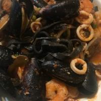 Spaghetti Neri · House-made squid ink pasta with shrimp, calamari and clams in a tomato broth.