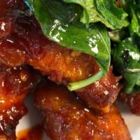 Chili Wings · Six pieces fried chicken wings topped with thai sweet chili sauce, bell pepper and fried bas...