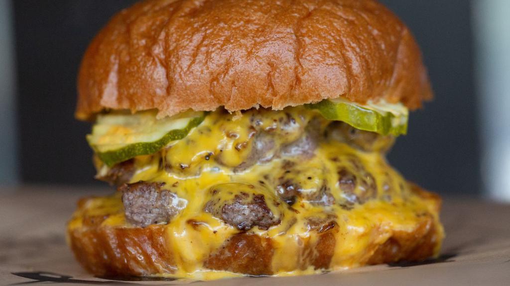 Kumar Burger · American cheese, pickles, griddled onions, smoked burger sauce