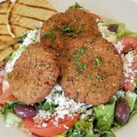 Falafel Plate · Four fresh-made falafels on a bed of hummus, topped with tahini, and chopped salad; served w...