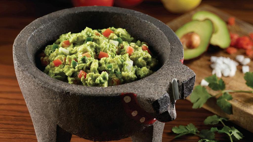 Guacamole · Made in-house with fresh Hass avocados,. Onions, cilantro, tomatoes and jalapenos.  Served with homemade chips.