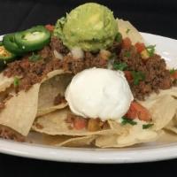 Pikes Peak Nachos · Corn tortilla chips piled high with seasoned ground beef, queso blanco, Pico de Gallo, jalap...