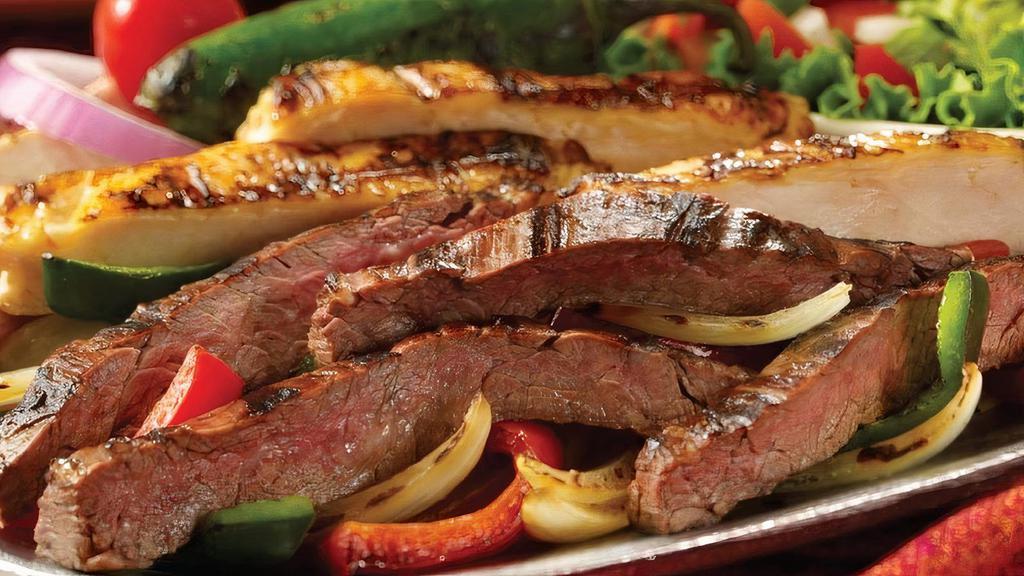 Steak And/Or Chicken Fajitas For Two · Premium carne asada steak and grilled chicken combo, served atop sauteed peppers and onions with fresh guacamole, sour cream, pico de gallo, Mexican rice, frijoles a la charra, and homemade flour tortillas.
