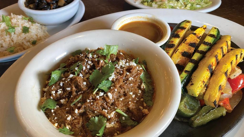 *New*Beef Barbacoa Fajitas · Tender adobo-rubbed beef, slow braised in savory Mexican spices, complemented with Grilled zucchini and squash, sautéed peppers & onions, crumbled cotija cheese, chopped cilantro, corn tortillas, cilantro rice and frijoles negros.