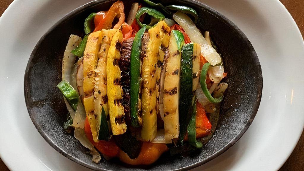 Grilled Vegetable Fajitas For One · Mesquite grilled vegetables including zucchini, yellow squash, portobello mushrooms, sautéed peppers, and onions. Served with fresh guacamole, sour cream, cheese, pico de gallo, with our homemade flour tortillas, Mexican rice and black beans.