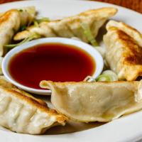 Potstickers (6) · Individually hand made, filled with ground pork, ginger, Napa cabbage while folded in a past...