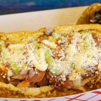 Estilo Sonora · Bun, bacon-rolled dog, topped with pinto beans, grilled onions, tomatoes, mayonnaise, mustar...