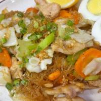 8. Bihon · Filipino food. Fine rice noodles stir fried with cabbages, carrots, celery, topped with gree...