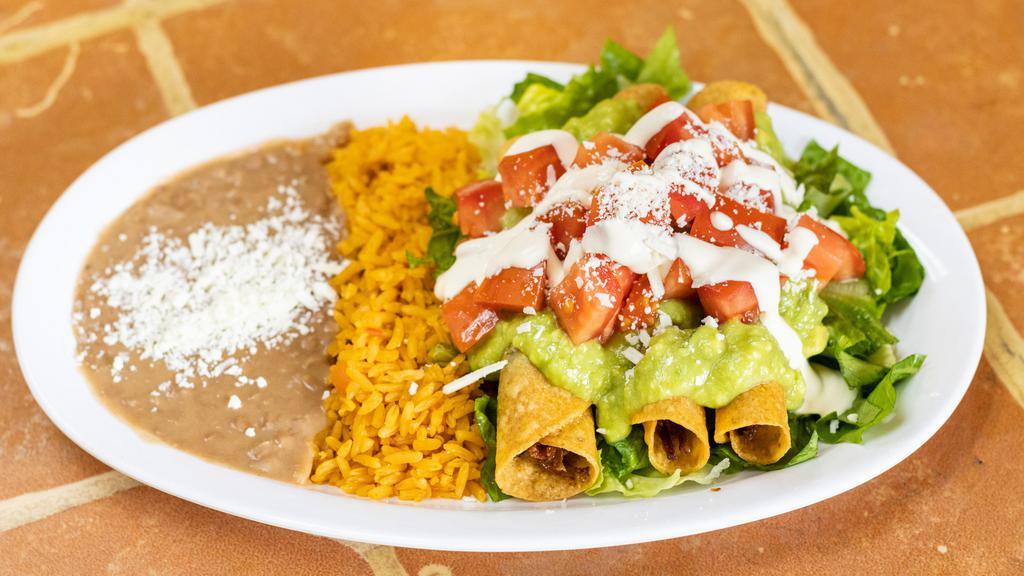 Taquitos Combo / Rolled Taquitos · 3 Rolled chicken taquitos topped with lettuce, tomatoes, cheese, sour cream and guacamole, with side of beans and rice.