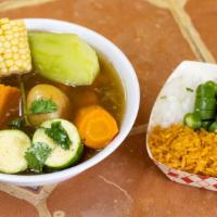 Caldo De Res · Beef soup with vegetables served with side rice onions and tortillas.