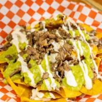 Super Nachos · Crunchy tortilla chips topped with refried beans with choice of meat cheese guacamole and so...