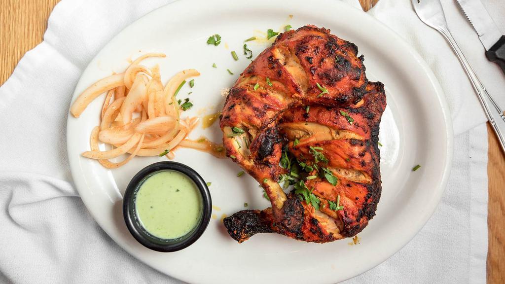 Tandoori Chicken Tikka · Marinated leg and thigh of chicken grilled over charcoal.