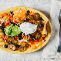 Super Nachos · Chips, cheese, beef or chicken with beans, tomatoes, onion, jalapenos, olives, sour cream, a...
