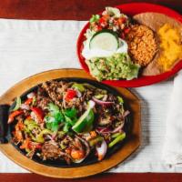 Chicken & Steak Combo Sizzling Cancun Fajitas · Fajitas sautéed with onions, green, and red peppers. Served with three flour or corn tortill...