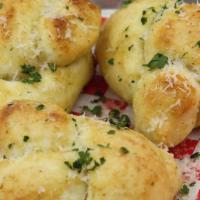 Garlic Knots · 3 of our awesome Garlic Knots topped with garlic butter and Parmesan Romano cheese and parsley