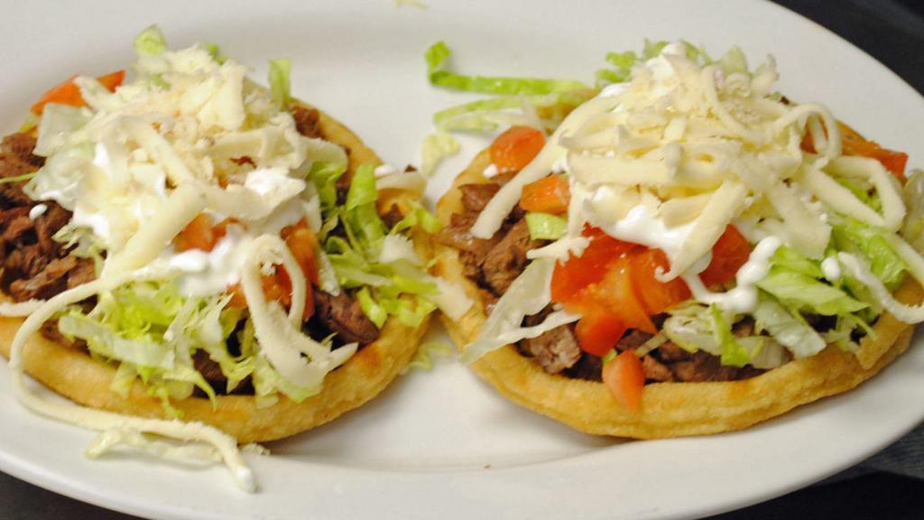 Sopes · Your choice of meat. Comes with beans, meat, sour cream, lettuce, & cheese.
