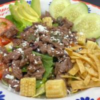 Ensalada Tapatia · Carne asada (grilled steak), romaine lettuce, spinach, tomatoes, onion, corn, avocado, black...