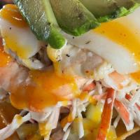 Tostada Loca · Crab meat, cooked shrimp, shripm cooked in lime, with scallops over pico de gallo and cucumb...