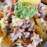 Tosticeviche De Camaron · tostitos salsa verde chips with shrimp ceviche  and a scoop of guacamole