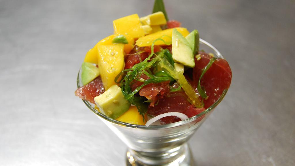 Poke Tuna · Our tapa house specialty. Fresh ahi tuna, avocado, mango, tossed with sea-salt, seaweed salad and sesame oil.