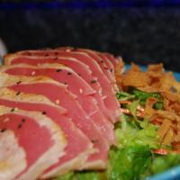 Seared Tuna Sashimi Salad · Our tapa house specialty. Seared ahi tuna over mixed greens with house specialty dressing.
