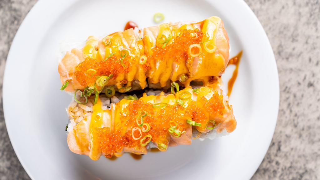 Volcano · Crab, avocado roll baked with Salmon, spicy eel sauce, spicy mayo and finished with scallions, tobiko.