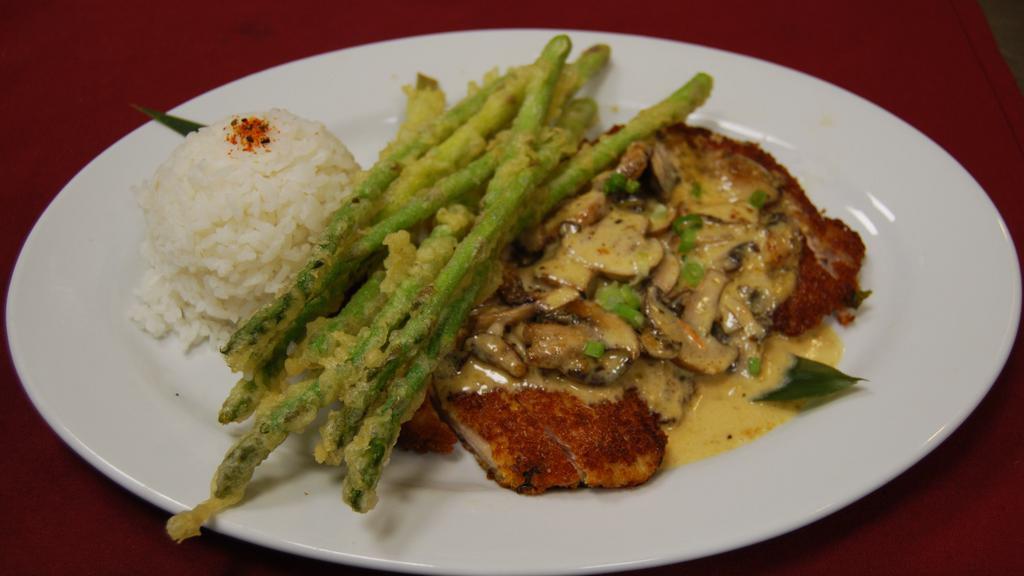 Katsu Chicken · Our tapa house specialty. Pan-seared hand-breaded chicken, with tempura asparagus and deep fried cilantro in a house specialty sauce.