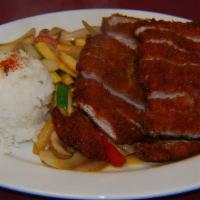 Tonkatsu · Breaded pork loin covered with japanese steak sauce and fresh sauteed vegetables and steamed...