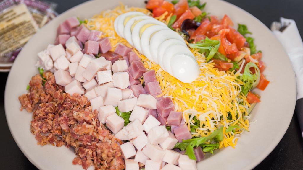 Chef Salad · Mixed Greens, turkey, ham, bacon bits, cheese, hard-boiled egg, and tomato.