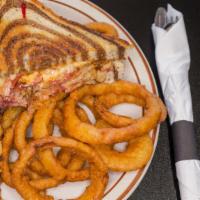 Reuben Sandwich · Grilled sliced corned beef, Swiss cheese, our own thousand island dressing, warm sauerkraut ...