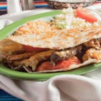 Fajita Quesadilla · Big size flour tortilla stuffed with grilled beef or chicken and melted cheese. Served with ...