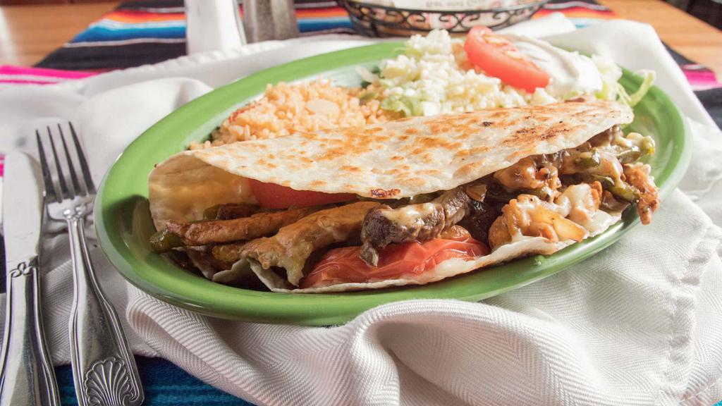 Fajita Quesadilla · Flour tortilla with choice of steak or chicken and cheese. Served with sour cream, guacamole, rice and beans.