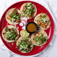 Pulled Pork Taco · Shredded slow cooked pork. Topped with cilantro, onions, radish, and lime. Served with house...