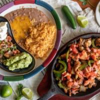 Lunch Fajitas · Grilled chicken or steak, cooked with tomatoes, onions, bell peppers. Served with rice, bean...