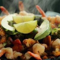 Cuervo Gold Fajitas · More than a half pound of jumbo prawns in a zesty tequila marinade, sautéed with red and gre...