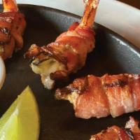 Baja Shrimp Appetizer · 4 jumbo shrimp stuffed with Monterey jack and jalapeno wrapped in bacon,. Served with a frot...