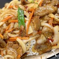 Mongolian Beef · Sliced tender beef, onions, carrots, hot pepper spicy sauce garnished on top of saifon noodl...