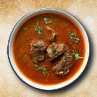 Lamb Korma  · Fine pieces of lamb cooked with tomato sauce, cream, and Indian spices.