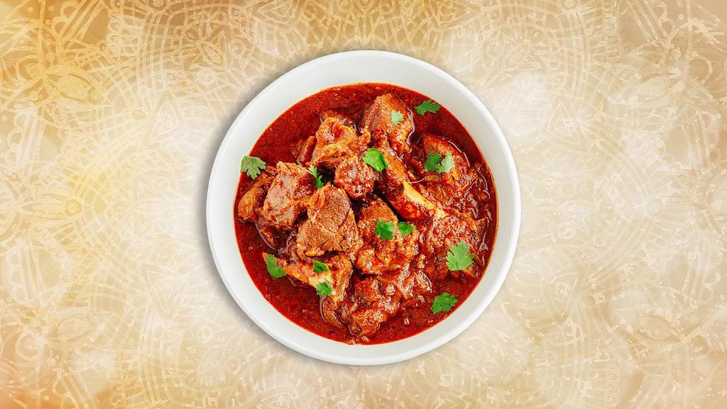 Goan Lamb Vindaloo · A special from the coastal state of Goa, boneless chunks of lamb, slow-cooked in a hot and tangy traditional red 'rechado' masala.